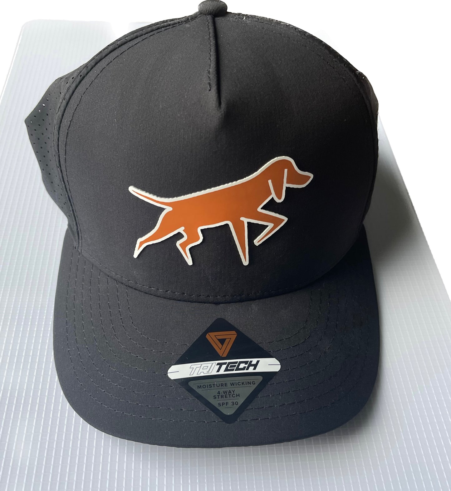 Dogged Life black perforated cap with Bongo Patch logo, moisture-wicking, 4-way stretch, SPF 30 lightweight design.